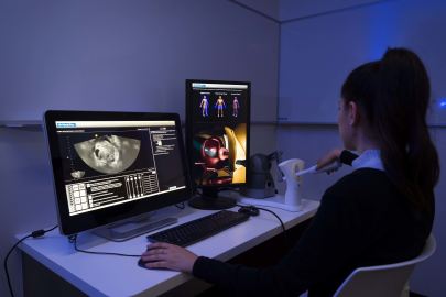 Medical sonography student using campus sonography simulator
